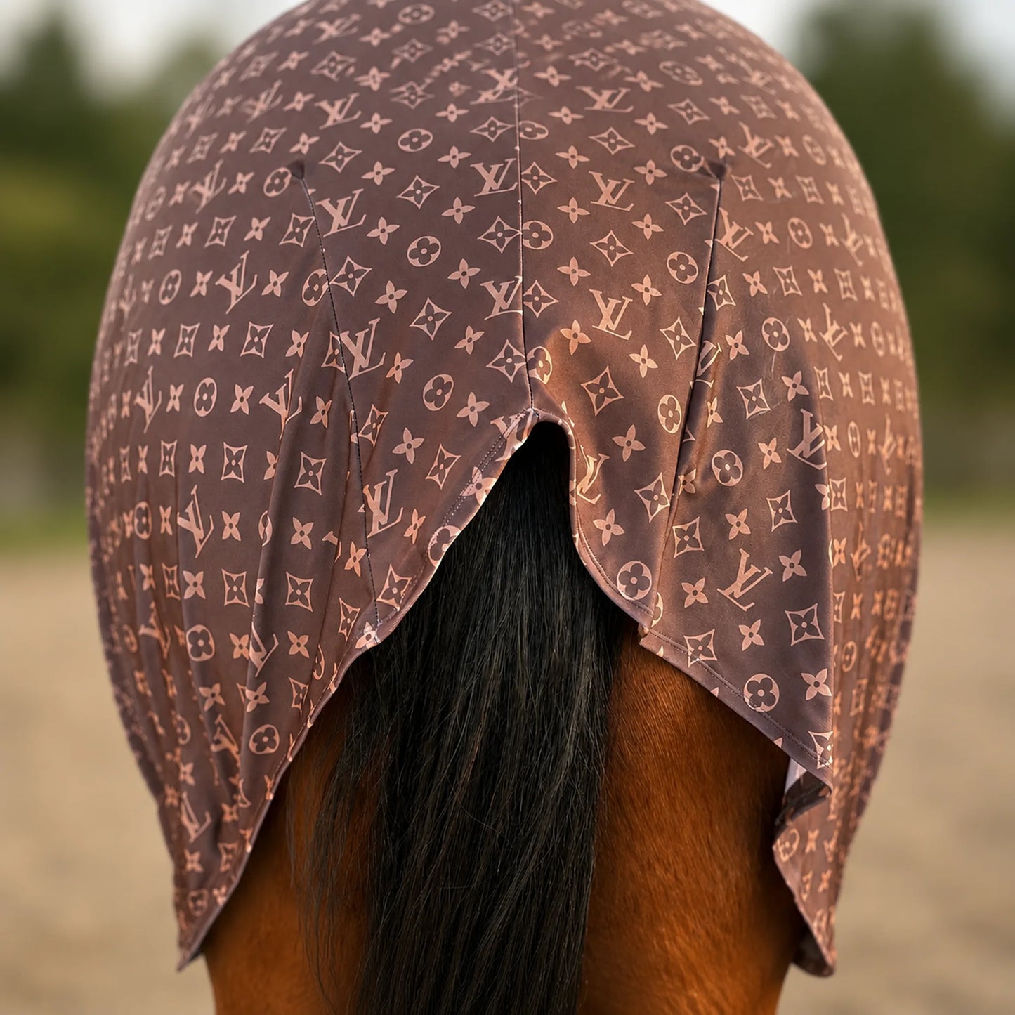 A brown horse blind with a LV brown full body sleazy, shown from behind on a horse with dark hair, set against a blurred outdoor background.