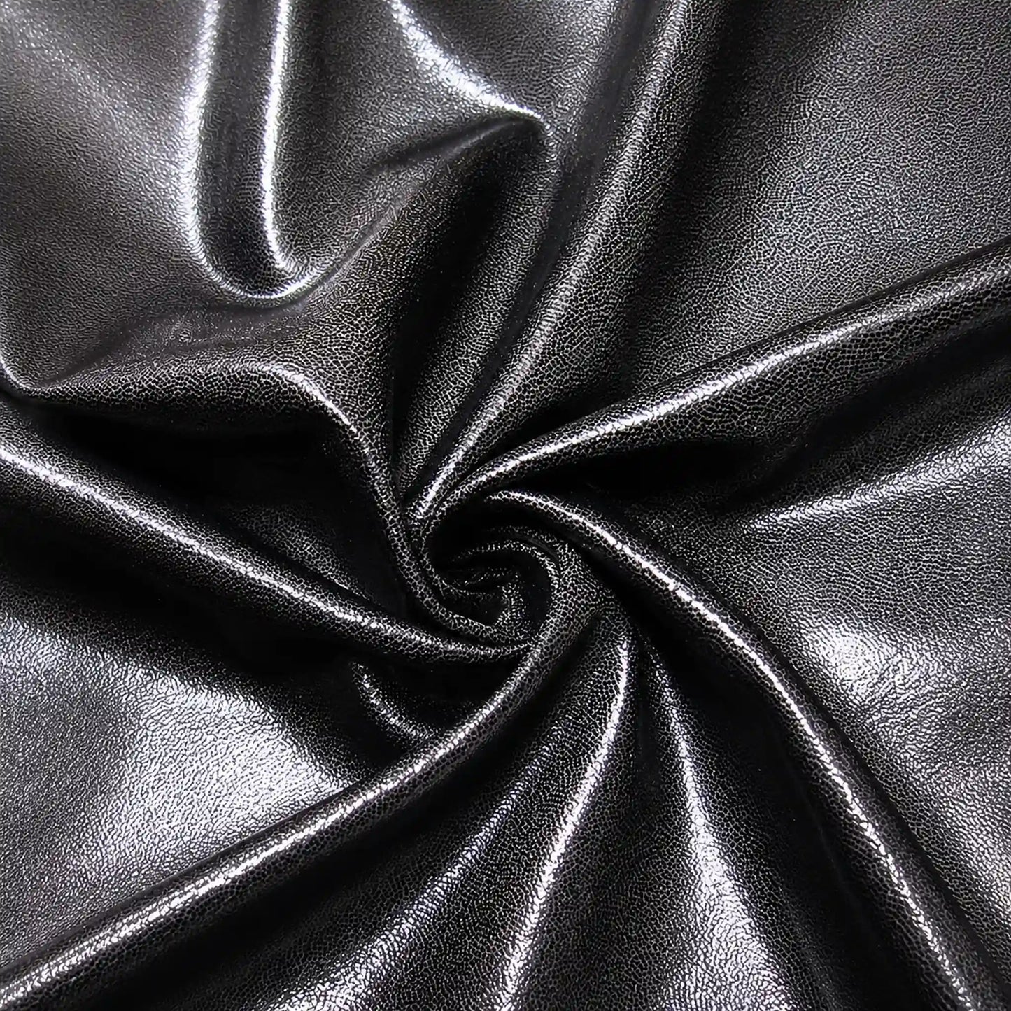 Close-up of metallic black fabric with folds