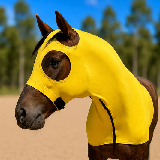 A brown horse wearing a bright yellow hood with eye and ear cutouts, photographed outdoors against a blurred background of trees and blue sky.