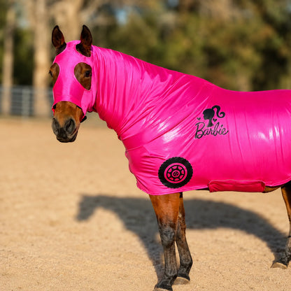 Horse wearing a bright pink Barbie-themed costume in an outdoor setting.