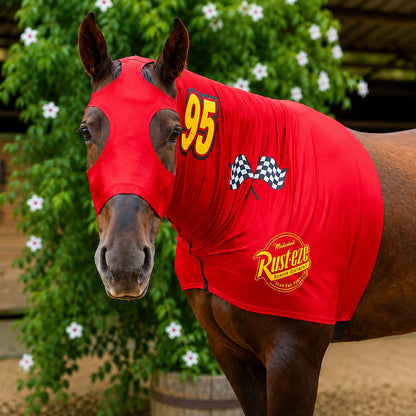 Horse wearing a red Lightning McQueen sleazy costume with number 95 and checkered pattern, standing in front of greenery.