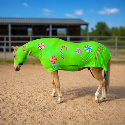 Horse wearing a metallic green candy sleazy with candy cane and lollipop patterns in an outdoor setting.