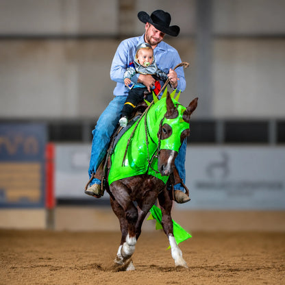 Man riding a metallic green dragon horse costume sleazy with matching tailbag in a rodeo setting