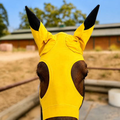 Horse wearing a yellow pikachu costume sleazy with black ears in an outdoor setting