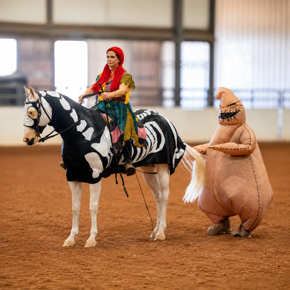 Person on a horse with a Skeleton horse costume sleazy  in an indoor arena.