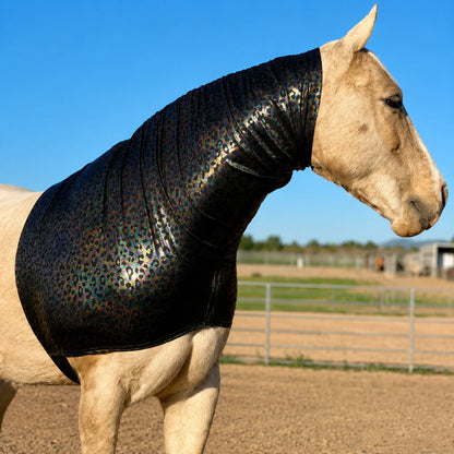 Horse wearing a shiny hologram leopard faceless hood sleazy in an outdoor setting