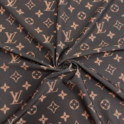 A close-up of a dark brown fabric with a repeating LV pattern, gathered in the center to show the material texture and print.