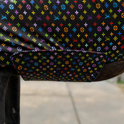 A close-up of a LV color full body sleazy, draped over a dark horse with a gray concrete ground in the background.