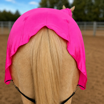 Bright metallic pink full body horse sleazy, shown from behind in an outdoor stable or arena.