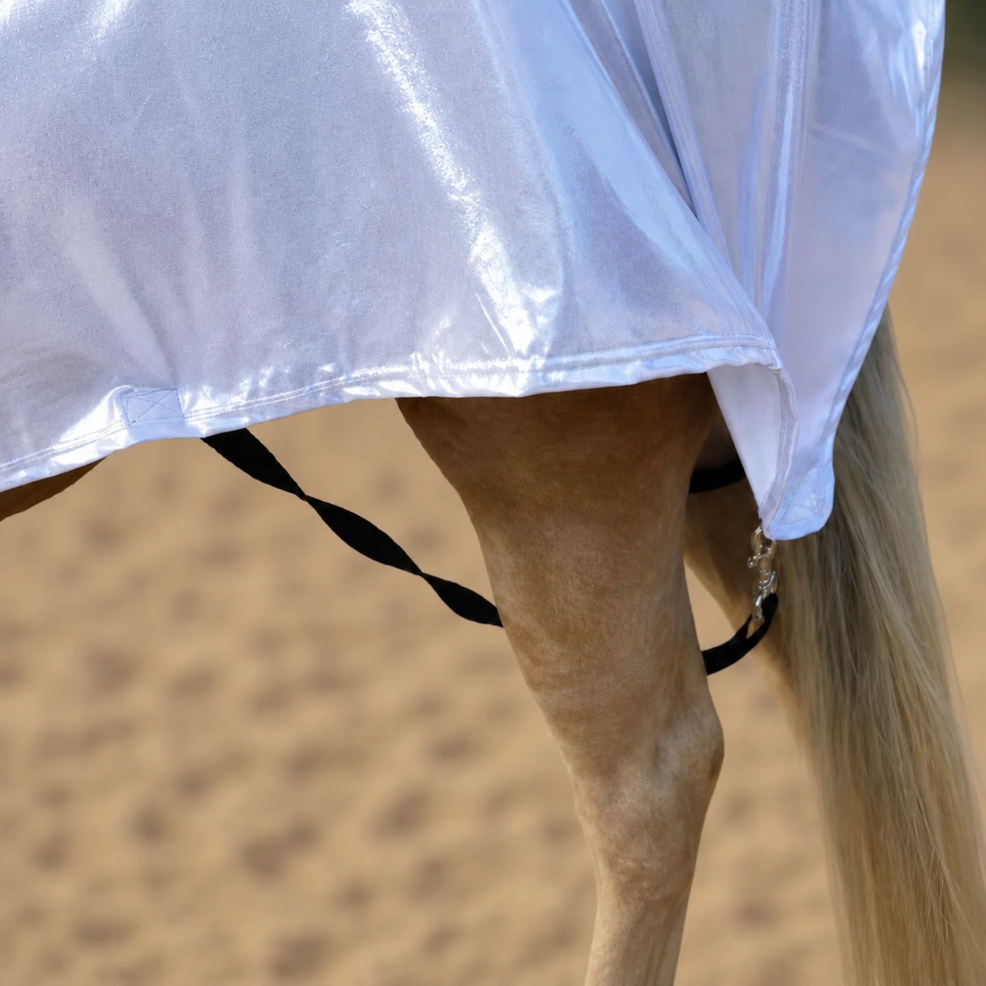 Shiny metallic silver faceless full body sleazy on a horse with leg straps and metal hardware
